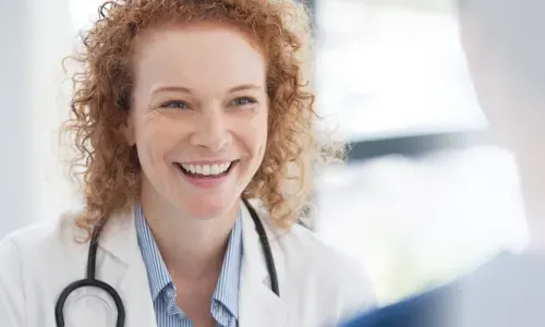 Public health nurse with DNP smiling during staff meeting